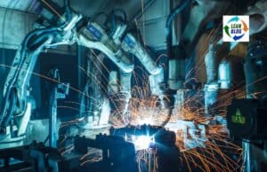 How a Simple Kaizen Idea at NUMMI Saved Hours of Work Automated industrial robots welding with sparks in a manufacturing setting.