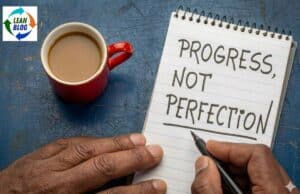 Why Toyota Knows Perfection Is Impossible: A NUMMI Lesson Progress, not perfection handwritten on notepad with coffee cup; emphasizes continuous improvement in Lean leadership.