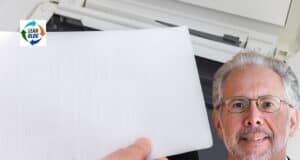 Why Lean Culture Is So Hard to Copy — Jeffrey Liker on Toyota Culture (Part 2) A man in glasses smiling, holding a printed document near a photocopy machine, emphasizing efficient document handling.