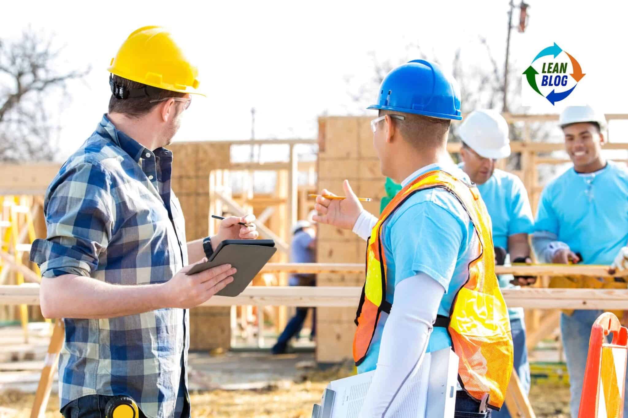 Hard hat safety conversation on a construction site with group of workers.