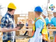 Toyota Invests In Workers Instead of Laying Them Off Hard hat safety conversation on a construction site with group of workers.