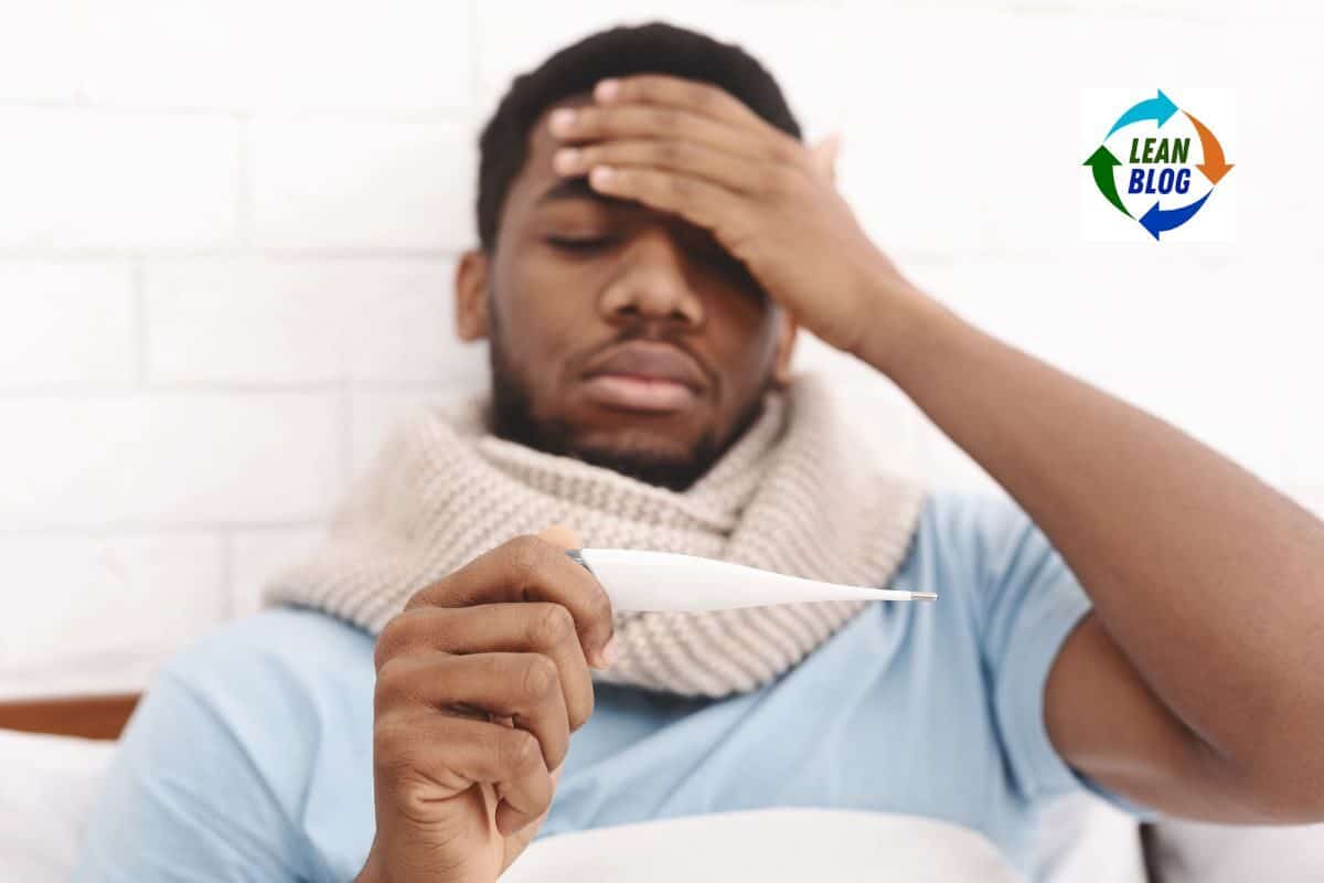 1. Man holding thermometer, appearing sick and tired in a healthcare setting.