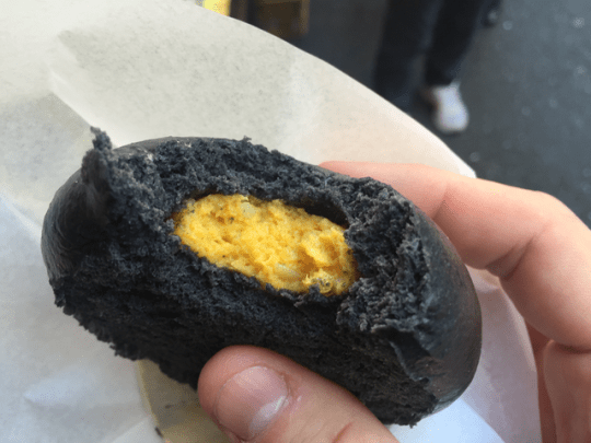 Street food...  a squid ink seamed bun with fish paste and sea urchin
