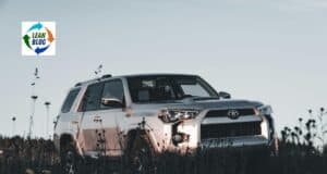 1. A silver Toyota SUV parked in a grassy field under a cloudy sky.