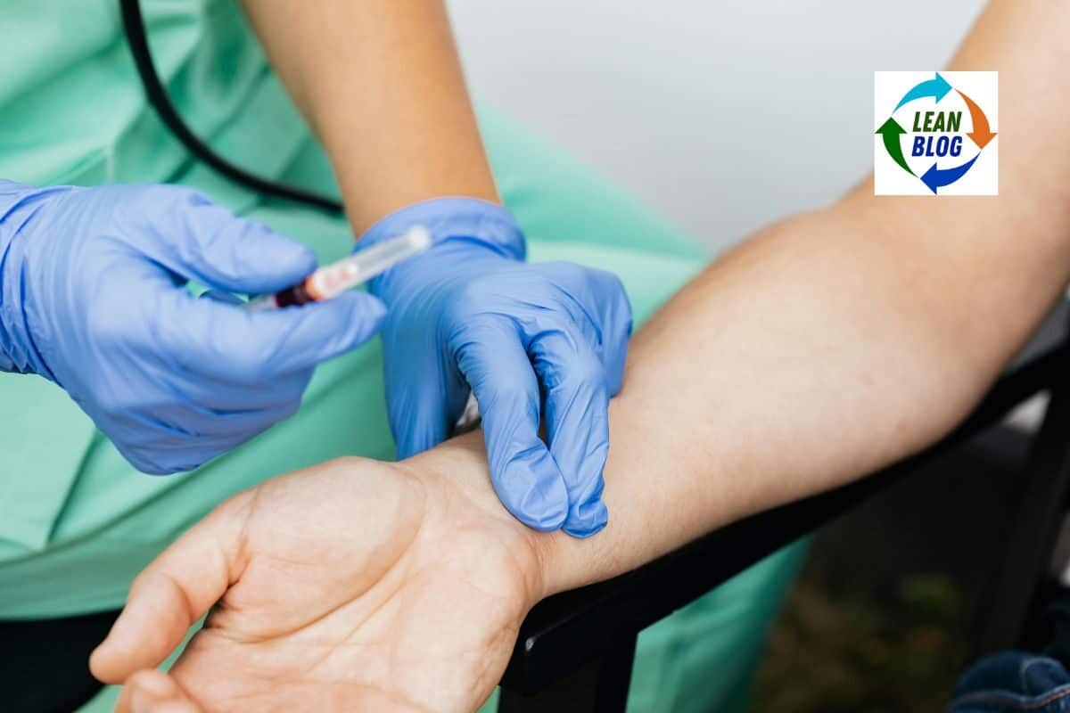 1. Nurse in green scrubs drawing blood from a patient's arm with a syringe.