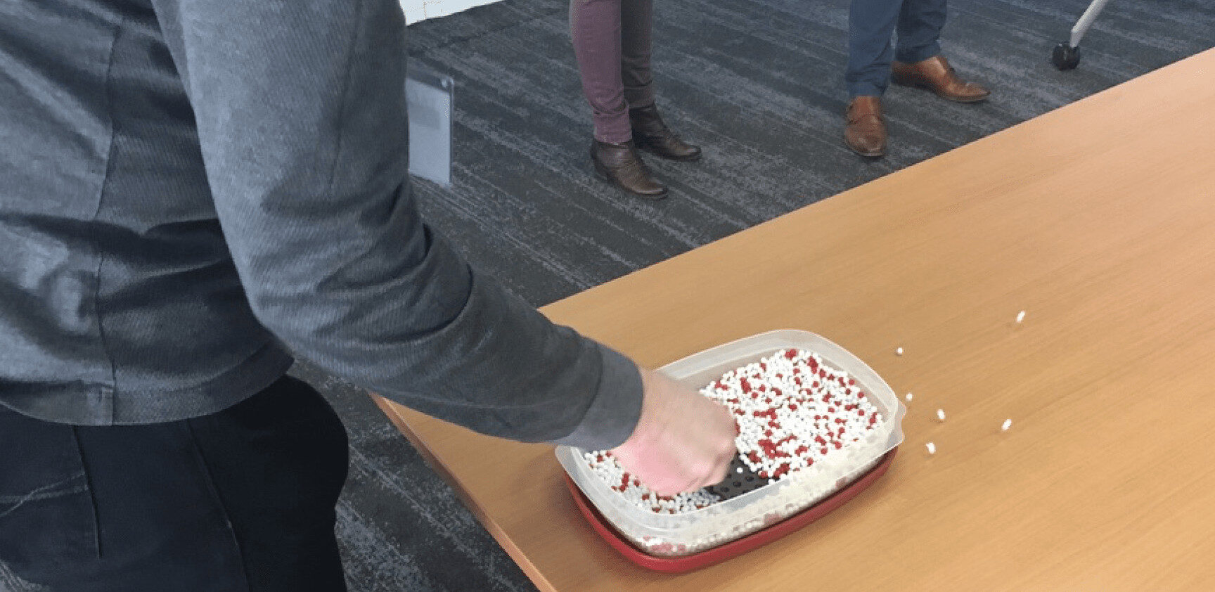 a workshop attendee playing the Red Bead Game (Deming)