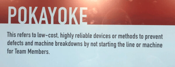 Poka-yoke display explaining mistake-proofing as low-cost, reliable methods that prevent defects and machine breakdowns before work begins.
