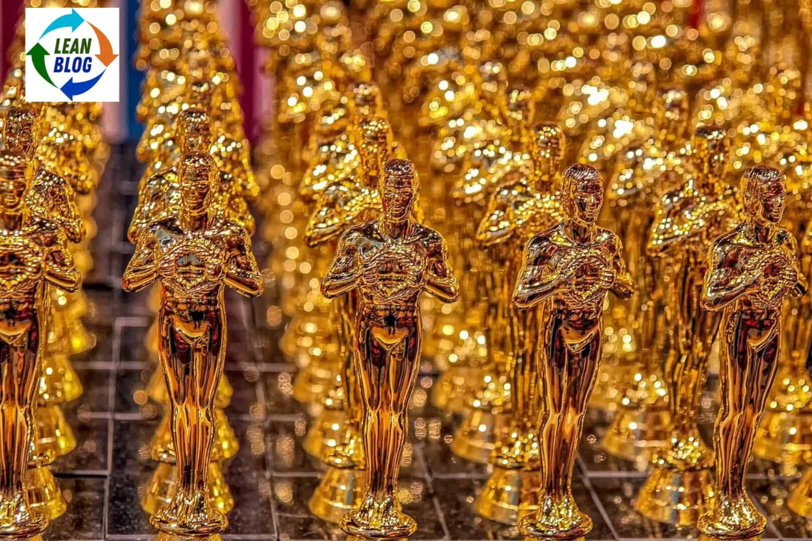 Golden Oscar-like award statues lined up in rows.