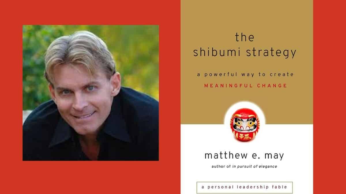 An image with a red background features two sections. On the left is a photo of a smiling man with blond hair and a black shirt. On the right is the cover of a book titled "the shibumi strategy: a powerful way to create MEANINGFUL CHANGE" by matthew e. may, author of "in pursuit of elegance." The cover also shows a Daruma doll.