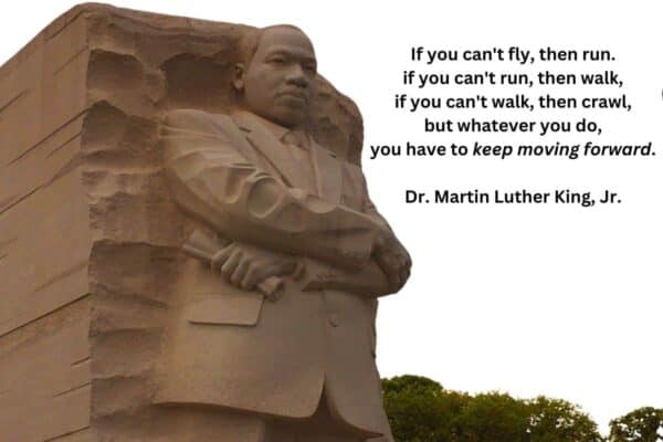 **Alt Text:** The image shows a large stone statue of Dr. Martin Luther King, Jr. on the left side. The right side contains the quote: "If you can't fly, then run. if you can't run, then walk, if you can't walk, then crawl, but whatever you do, you have to keep moving forward." Below the quote, it says "Dr. Martin Luther King, Jr."