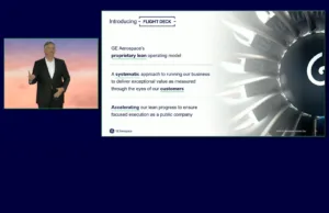 Inside GE Aerospace’s Flight Deck: How Larry Culp Leads with Lean and Safety First **Alt Text:** A presentation slide from GE Aerospace's Investor Day featuring CEO Larry Culp. The slide is titled "Introducing - FLIGHT DECK" and includes the following text: - GE Aerospace's **proprietary lean operating model** - A **systematic** approach to running our business to deliver exceptional value as measured through the eyes of our **customers** - **Accelerating** our lean progress to ensure focused execution as a public company Larry Culp is pictured on the left side of the slide, wearing a black suit and speaking against a backdrop with a gradient of warm colors. On the right side, there is an image of a turbine or engine component. The GE Aerospace logo is displayed at the bottom, and the slide is marked "2024 GE Aerospace Investor Day" with the page number 13.