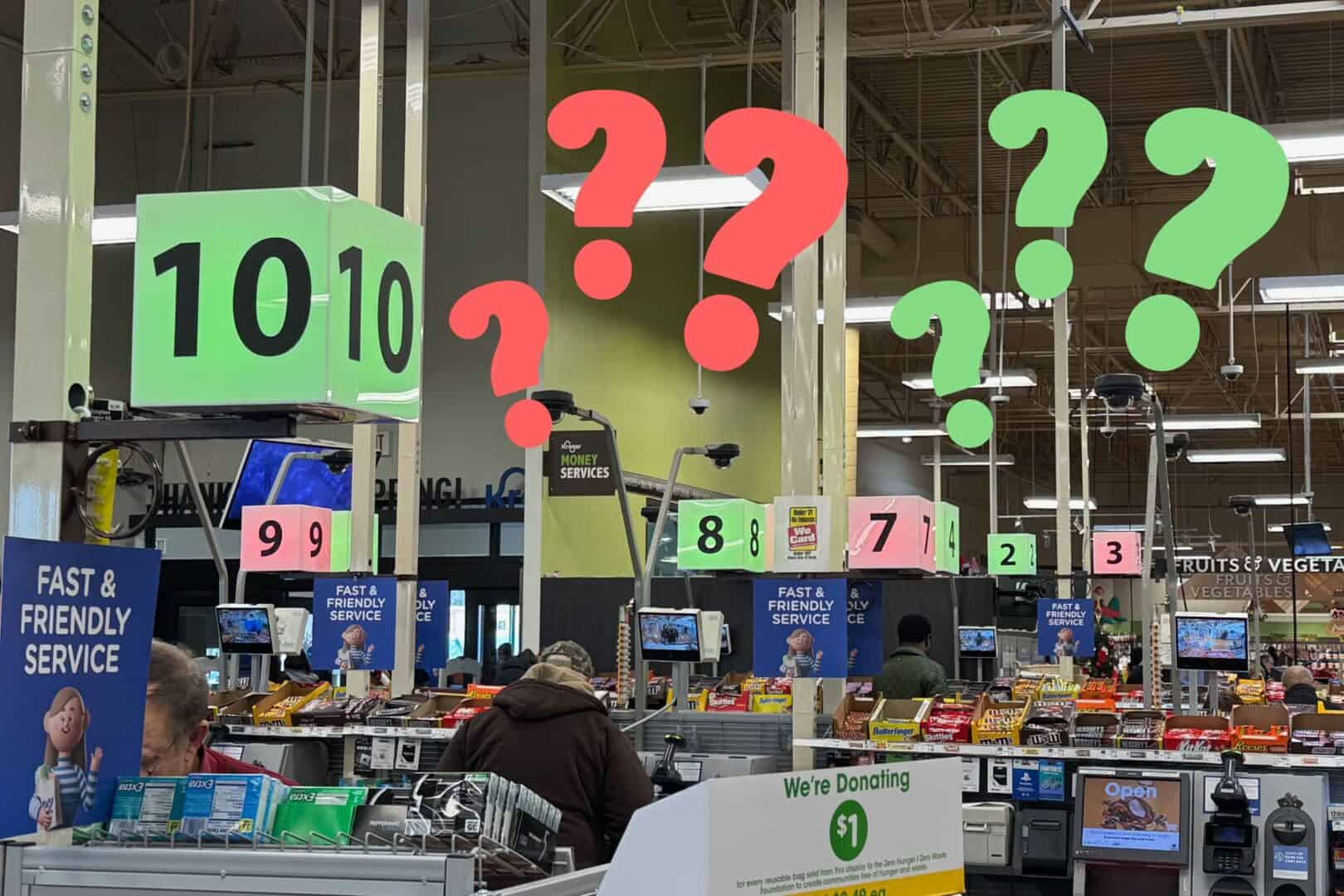 Photo of a grocery store with checkout register signs that are lit of red or green