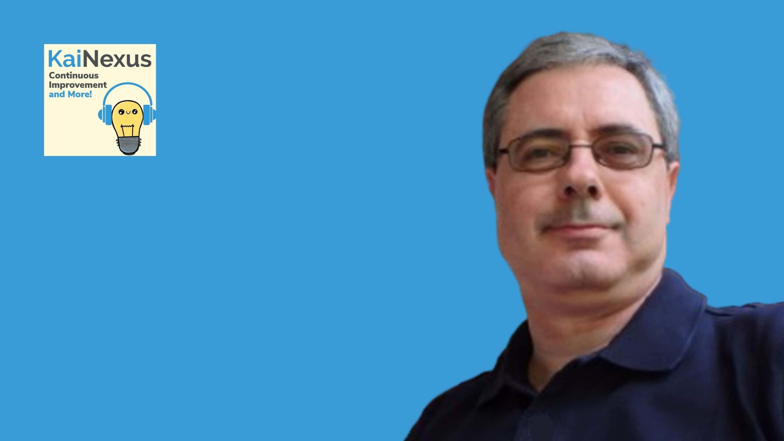 Innovative man with glasses smiling against a blue background, symbolizing continuous improvement.