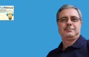 Digital Support for a Culture of Improvement: A Reflection on Electrolux and KaiNexus Innovative man with glasses smiling against a blue background, symbolizing continuous improvement.