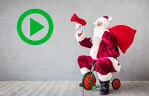 Gemba Claus Is Comin’ to Town: A Lean Christmas Song Parody Play button icon next to Santa riding a tricycle with a large red sack, against a plain wall background.
