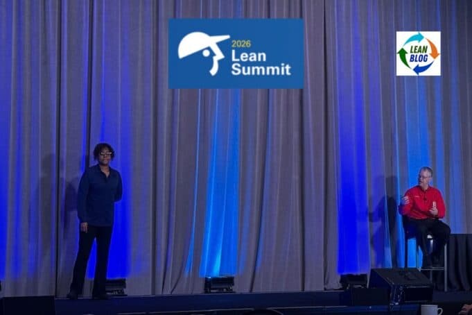 The Most Misunderstood Role in the Toyota Production System Michelle Thomas and Jamie Bonini of Toyota's Production System Support Center (TSSC) speaking on stage at the 2026 Lean Summit, with blue uplighting and a gray curtain backdrop.