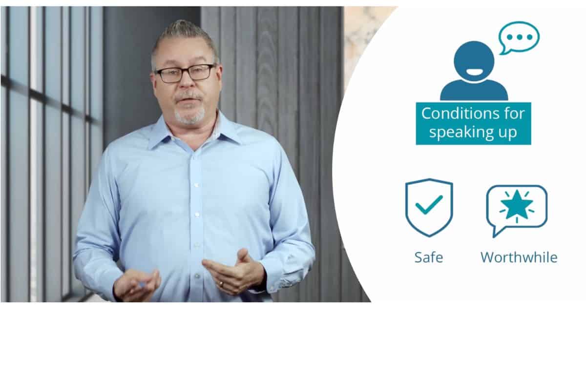 Man in light blue shirt standing indoors next to icons indicating conditions for speaking up, safe, and worthwhile.